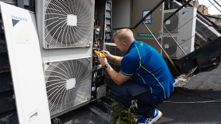 An Aspect air conditioning engineer service the external part of a split system.