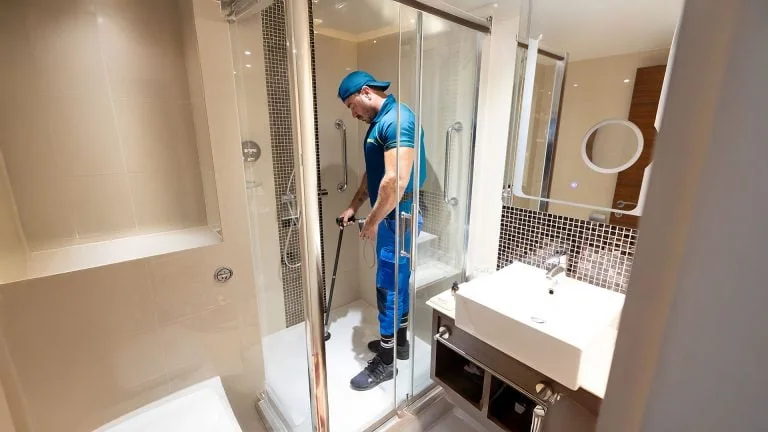 Shower leak detection by an Aspect tradesperson at a hotel using tracer gas